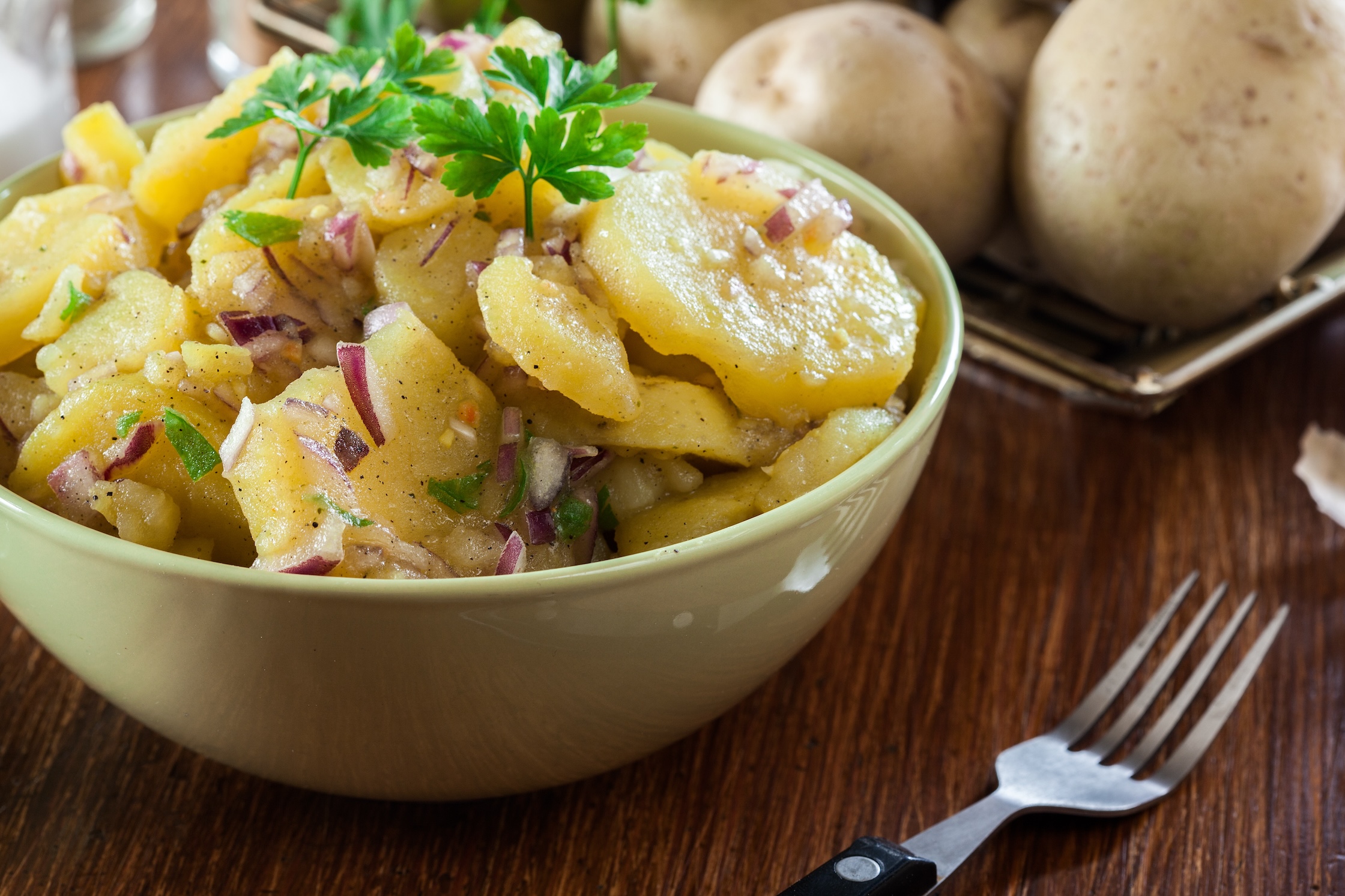 Potato salad with fresh parsley decorated on top