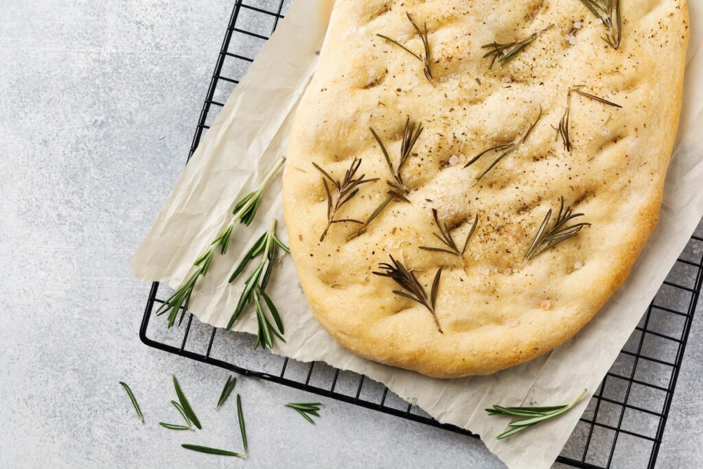 Italian traditional focaccia bread baking with Rosemary